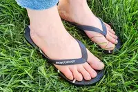 A person wears the Shower Shoez Women