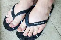 A person wears the Shower Shoez Women