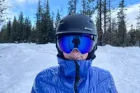 A person wearing the Smith I/O Mag Goggles while skiing