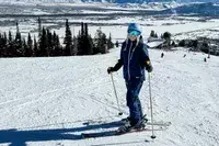 A person wearing the Smith I/O Mag Goggles while skiing