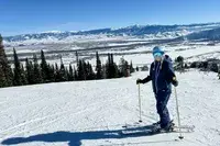 A person wearing the Smith I/O Mag Goggles while skiing
