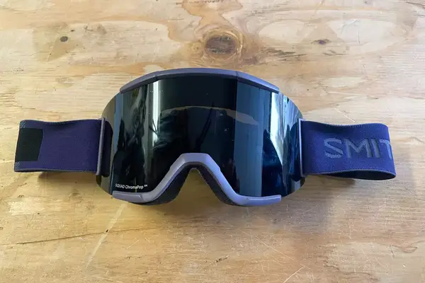 Smith Squad Goggles laying on a wooden surface