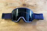 Smith Squad Goggles laying on a wooden surface