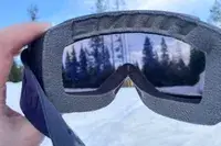 A person holding the Smith Squad Goggles outside