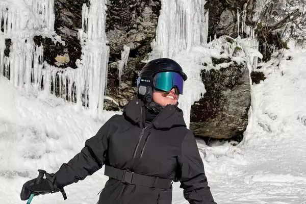 A person wearing the Dragon NFX Mag OTG goggles while skiing