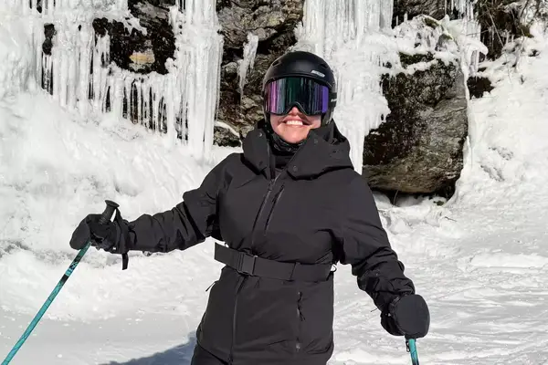 A person wearing the Dragon NFX Mag OTG goggles while skiing
