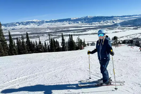 A person wearing the Smith I/O Mag Goggles while skiing