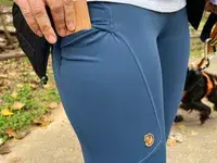 A person places an item into the side pocket of the FjÃ¤llrÃ¤ven Women