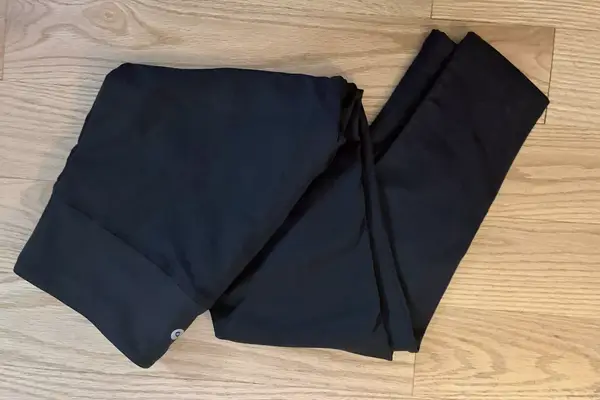 Person wearing lululemon Wunder Train High-Rise Tight with Pockets with packed suitcase in background