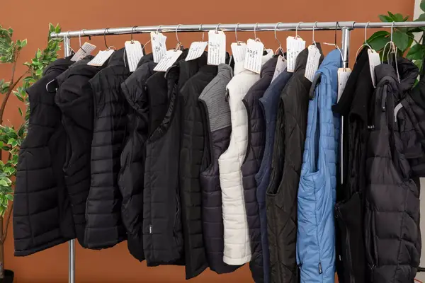 A person holds the battery pack for the Ororo Women’s Heated Recycled Fleece Vest