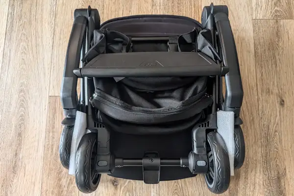 Joolz Aer+ Lightweight Stroller placed on a wooden floor showing wheels and a storage compartment