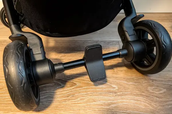 The bottom section of Joolz Aer+ Lightweight Stroller showing its wheels and foot brake