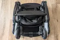 Joolz Aer+ Lightweight Stroller placed on a wooden floor showing wheels and a storage compartment