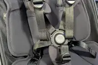 Closeup of a harness system with straps and a central buckle of Joolz Aer+ Lightweight Stroller