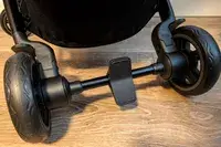 The bottom section of Joolz Aer+ Lightweight Stroller showing its wheels and foot brake