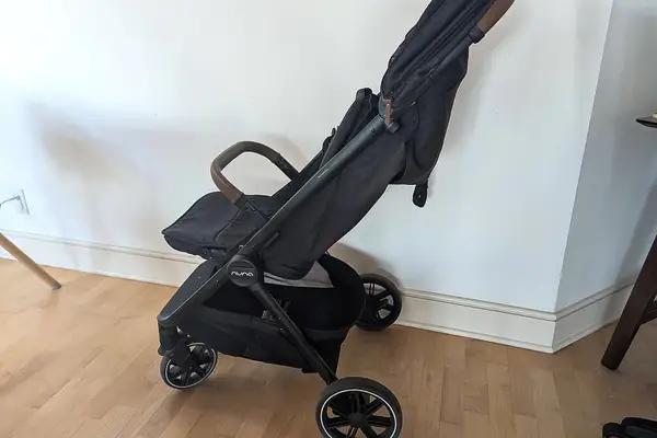 Nuna TRVL LX Stroller positioned in a room with hardwood flooring