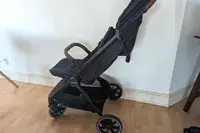 Nuna TRVL LX Stroller positioned in a room with hardwood flooring