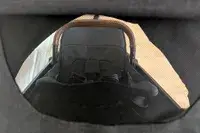 Nuna TRVL LX Stroller view from behind a mesh showing the handle and seating area
