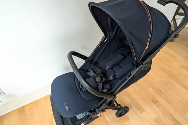 The Peg Perego Volo Compact Stroller on a wooden floor