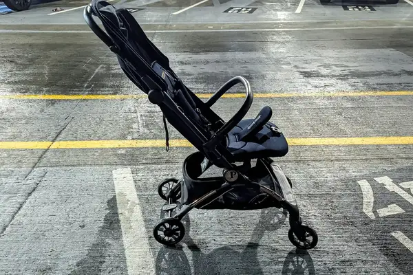 A side view of the Peg Perego Volo Compact Stroller with the canopy folded up