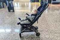 A baby sits in the Peg Perego Volo Compact Stroller