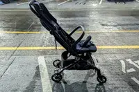 A side view of the Peg Perego Volo Compact Stroller with the canopy folded up