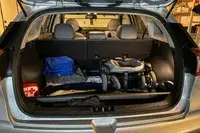 The Uppababy Minu V3 Travel Stroller folded in the back of a car