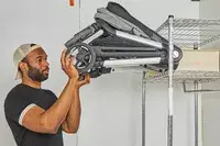 A person lifting the Thule Shine onto a rack shelf