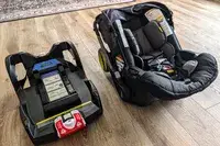 The Doona + Car Seat and base on a wooden floor