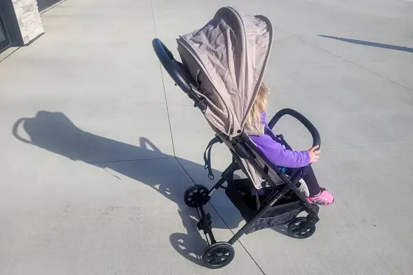A child sits in the Inglesina Quid Stroller
