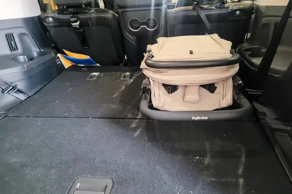 The Inglesina Quid Stroller folded in the back of a car