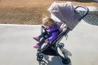 A child sits in the Inglesina Quid Stroller