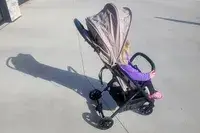 A child sits in the Inglesina Quid Stroller