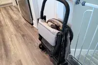 The Inglesina Quid Stroller folded leaning against a wall