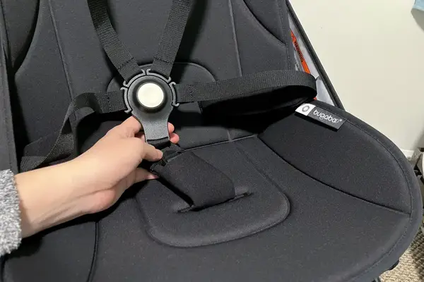 A person holds the lock on the Bugaboo Butterfly Stroller