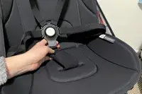 A person holds the lock on the Bugaboo Butterfly Stroller