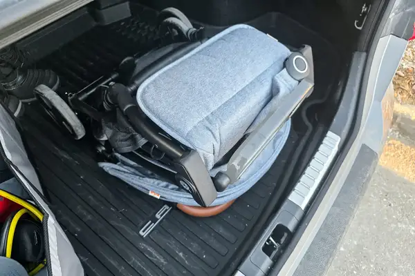 The Zoe The Traveler Stroller folded in the back of a car
