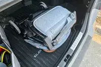 The Zoe The Traveler Stroller folded in the back of a car