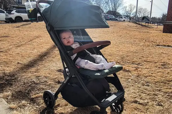 A baby in the Bombi Bēbee V2 Lightweight Stroller