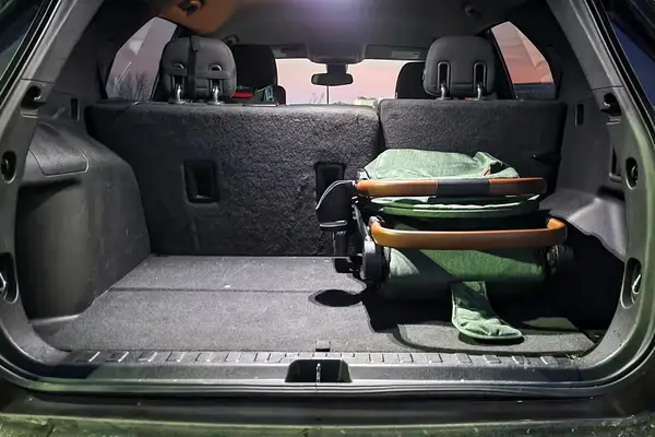 The Bombi Bēbee V2 Lightweight Stroller folded in the back of a car