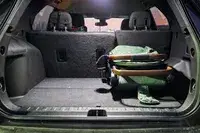 The Bombi Bēbee V2 Lightweight Stroller folded in the back of a car