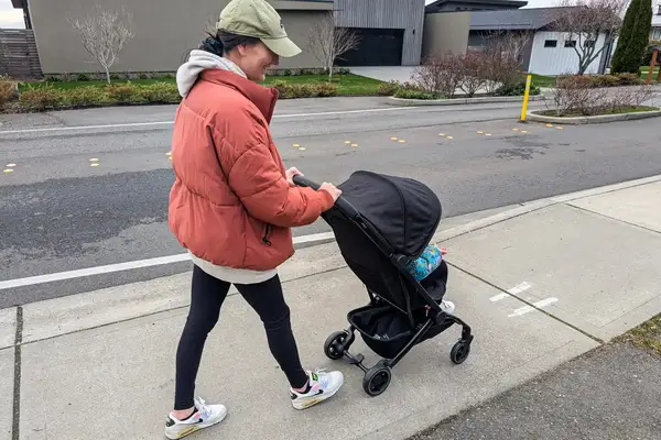 A person walking outside pushing Joolz Aer+ Lightweight Stroller on a sidewalk