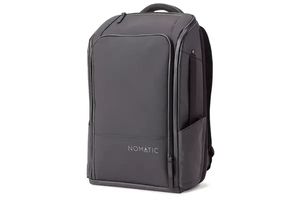 A person adjusts the waist strap on the Cotopaxi Allpa 42L Travel Pack