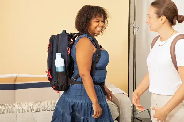 A person packs clothing into the Cotopaxi Allpa 42L Travel Pack