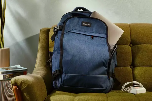 A person prepares to pack the Cotopaxi Allpa 42L Travel Pack