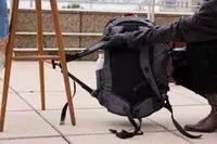 A person lifts up the strap on the Pacsafe Venturesafe EXP45 Anti-Theft Carry-On Travel Pack