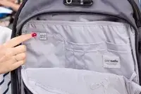 A person points to a RFID Safe tag on the Pacsafe Venturesafe EXP45 Anti-Theft Carry-On Travel Pack
