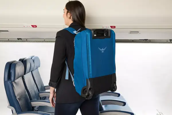 A person wearing the Osprey Daylite Wheeled Duffel 40L on their back