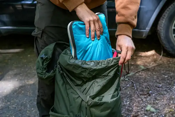 Person packing a Osprey Kestrel 58L Men