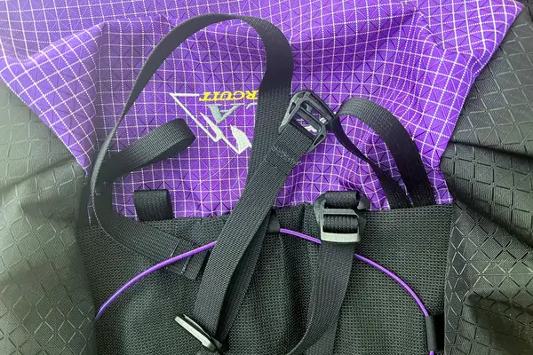 Close-up of ULA Equipment Circuit straps and purple-checkered fabric